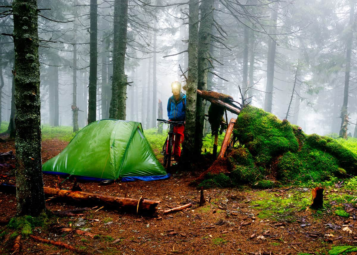 Setting up a tent in the rain